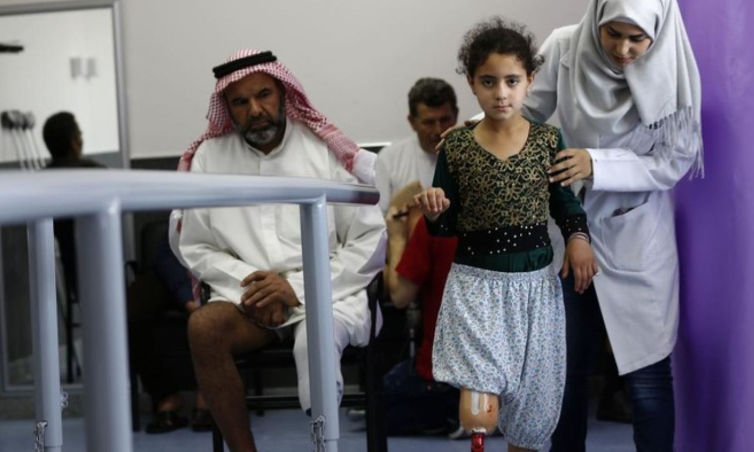 Patients and war victims try to use their new prosthetic limbs at a Syrian Red Crescent center near Damascus - July 2018 (AFP/Louai Beshara)